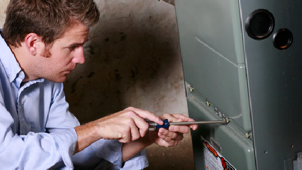 Service Man Working on Furnace | Leto Plumbing & Heating, Inc.